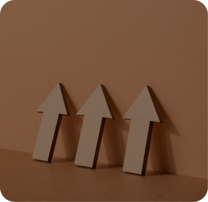 Three wooden arrows on a brown background for SEO services.